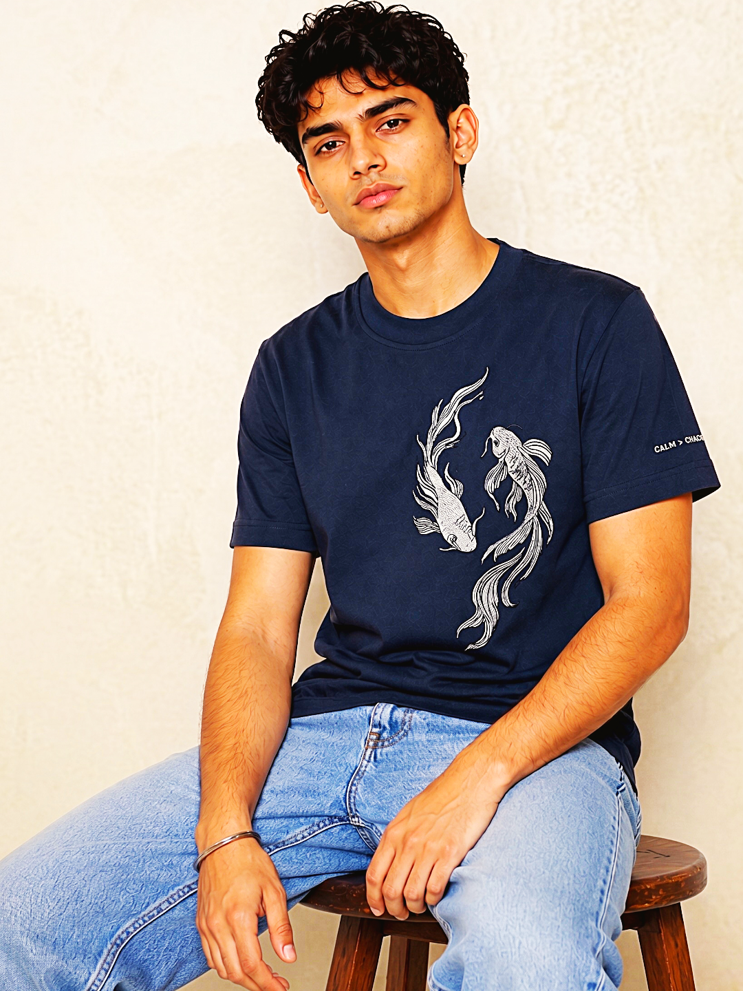Navy koi embroidered t-shirt seated lifestyle – 13thirtystudios Calm Chaos